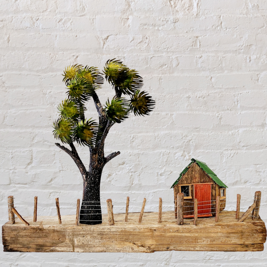 Cabbage tree & Shed on totara post