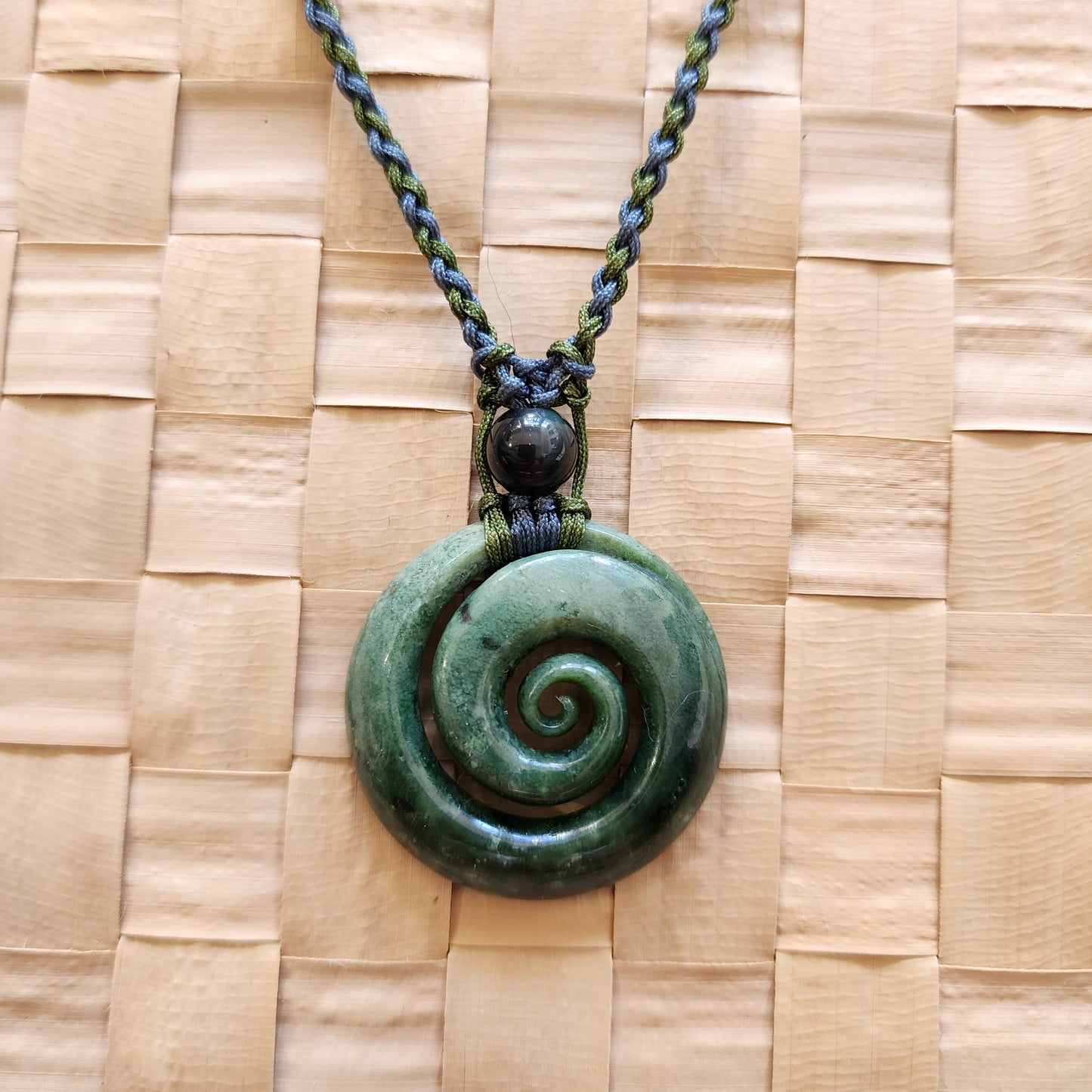 Koru with obsidian bead