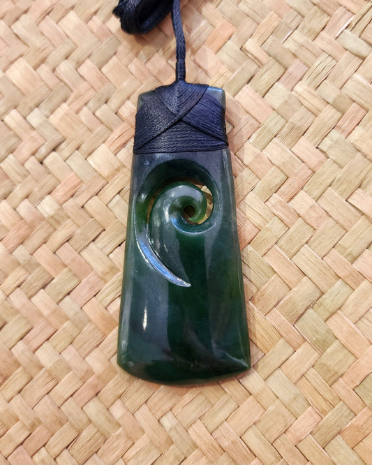 Toki with carved koru long Pounamu